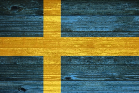 Sweden Flag painted on old wood plank backgroundの写真素材