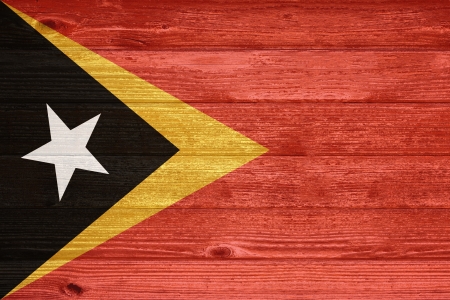 East Timor Flag painted on old wood plank backgroundの写真素材