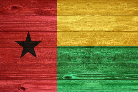 Guinea Bissau Flag painted on old wood plank backgroundの写真素材