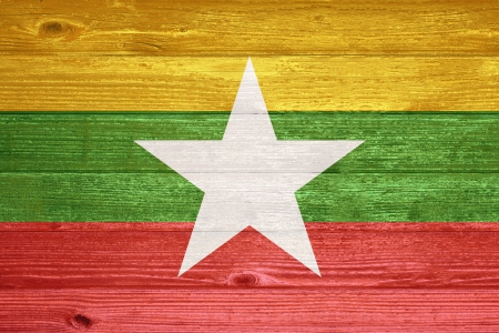 Myanmar Flag painted on old wood plank backgroundの写真素材