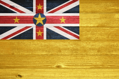 Niue Flag painted on old wood plank backgroundの写真素材
