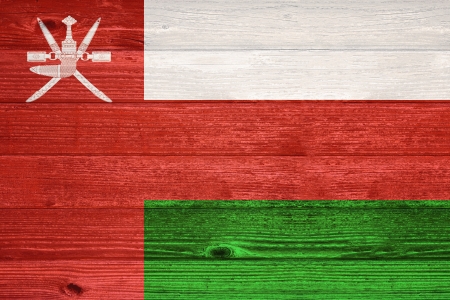 Oman Flag painted on old wood plank backgroundの写真素材