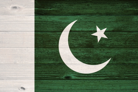 Pakistan Flag painted on old wood plank backgroundの写真素材