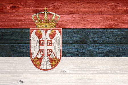 Serbia Flag painted on old wood plank backgroundの写真素材