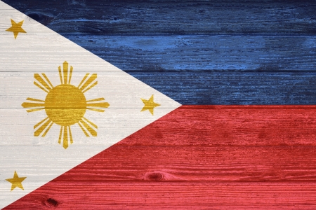 The Philippines Flag painted on old wood plank backgroundの写真素材