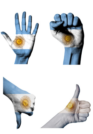 hands with multiple gestures (open palm, closed fist, thumbs up and down) with Argentina flag painted isolated on whiteの写真素材