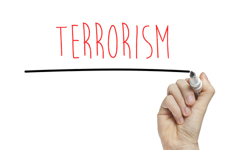Hand writing terrorism on a white boardの写真素材