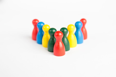Leadership concept with one game figurine in front of whole team in different colorsの写真素材