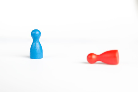 Business defeat or bowing to the king concept with game pieces on whiteの写真素材