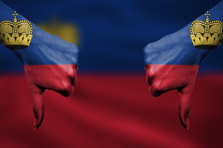 failure of Liechtenstein - hands gesturing thumbs down in front of flagの写真素材