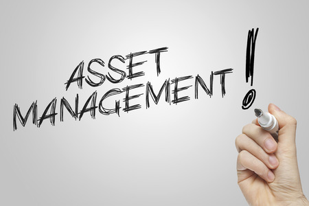 Hand writing asset management on grey backgroundの写真素材