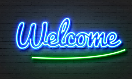 Welcome neon sign on brick wall backgroundの写真素材