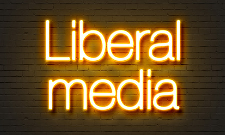 Liberal media neon sign on brick wall backgroundの写真素材