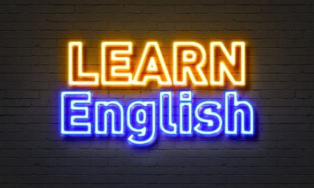 Learn English neon sign on brick wall backgroundの写真素材