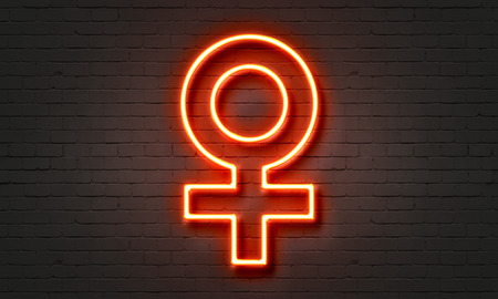 Female symbol neon sign on brick wall backgroundの写真素材