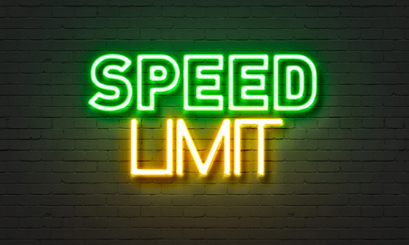 Speed limit neon sign on brick wall background