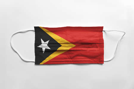 Face mask with East Timor flag printed, on white background, isolated.の写真素材