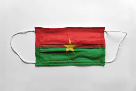 Face mask with Burkina Faso flag printed, on white background, isolated.の写真素材