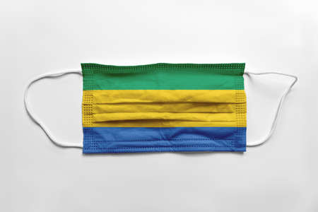Face mask with Gabon flag printed, on white background, isolated.の写真素材