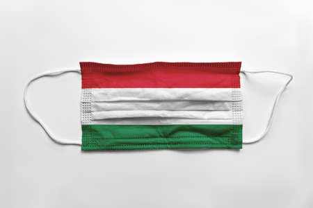Face mask with Hungary flag printed, on white background, isolated.の写真素材