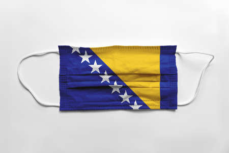 Face mask with Bosnia and Herzegovina flag printed, on white background, isolated.の写真素材