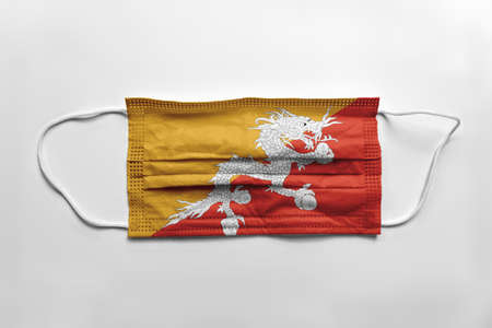 Face mask with Bhutan flag printed, on white background, isolated.の写真素材