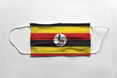 Face mask with Uganda flag printed, on white background, isolated.の写真素材