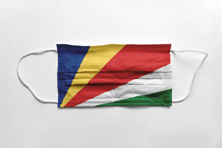Face mask with Seychelles flag printed, on white background, isolated. Covid-19 concept.の写真素材