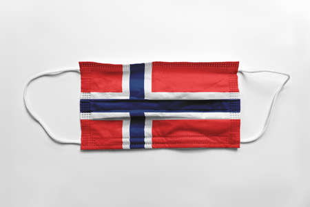 Face mask with Norway flag printed, on white background, isolated. Covid-19 concept.の写真素材
