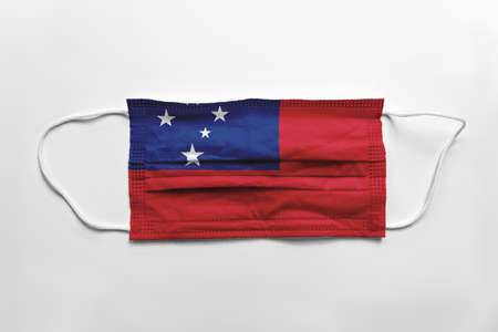 Face mask with Samoa flag printed, on white background, isolated. Covid-19 concept.の写真素材