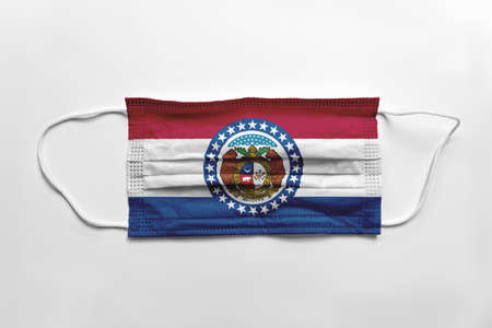 Face mask with Missouri flag printed, on white background, isolated safety conceptの写真素材
