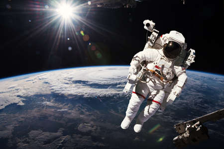 Astronaut walking in space with earth background.の写真素材
