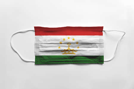 Face mask with Tajikistan flag printed, on white background, isolated.の写真素材