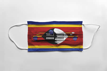 Face mask with Swaziland flag printed, on white background, isolated.の写真素材