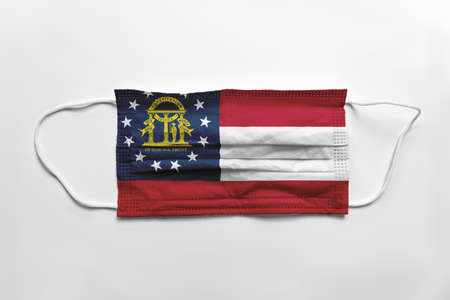 Face mask with Georgia flag printed, on white background, isolated safety conceptの写真素材