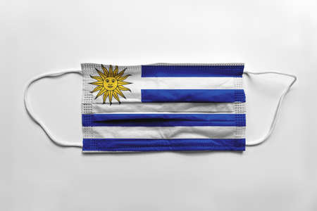 Face mask with Uruguay flag printed, on white background, isolated.の写真素材