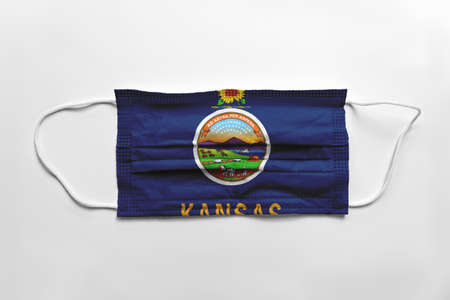 Face mask with Kanzas flag printed, on white background, isolated safety conceptの写真素材
