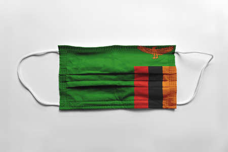 Face mask with Zambia flag printed, on white background, isolated.の写真素材