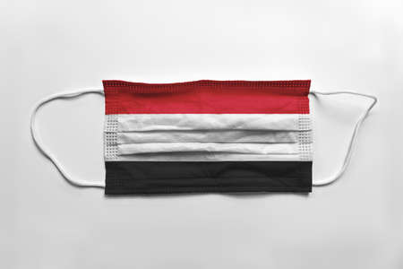 Face mask with Yemen flag printed, on white background, isolated.の写真素材