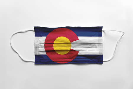 Face mask with Colorado flag printed, on white background, isolated safety conceptの写真素材
