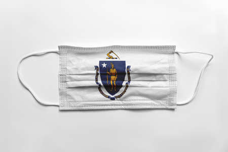 Face mask with Massachusetts flag printed, on white background, isolated safety conceptの写真素材