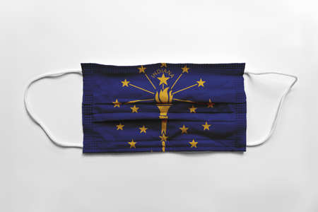 Face mask with Indiana flag printed, on white background, isolated safety conceptの写真素材