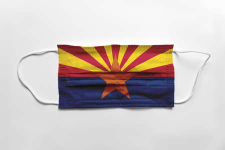 Face mask with Arizona flag printed, on white background, isolated safety conceptの写真素材