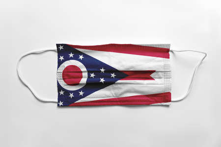 Face mask with Ohio flag printed, on white background, isolated safety conceptの写真素材