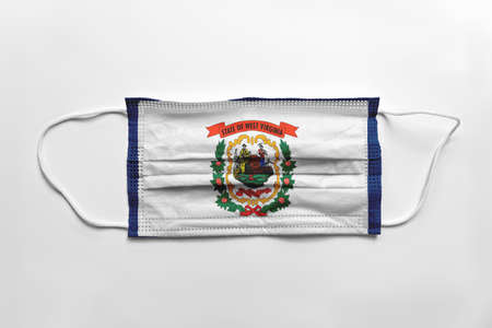 Face mask with West Virginia flag printed, on white background, isolated safety conceptの写真素材
