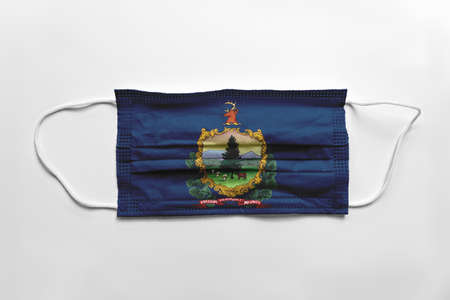 Face mask with Vermont flag printed, on white background, isolated safety conceptの写真素材