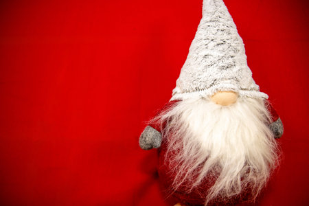 A Christmas toy santa on a velvet red backgroundの写真素材