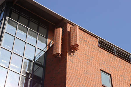 A 4G and 5G mobile phone mast disguised as the bricks of the building on an office block in the Leeds city centre in the UK, the hidden phone mask matches the buildingの写真素材