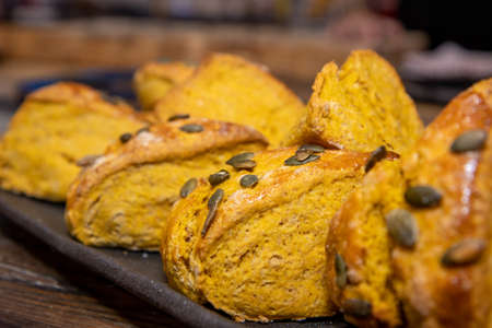 A delicious plate of pumpkin spice scones on a kitchen work top