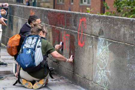 Leeds UK, 18th July 2019: The Extinction Rebellion Protest located in the Leeds City Centre on Victoria Bridge showing the protesters cleaning up after the protest.のeditorial素材